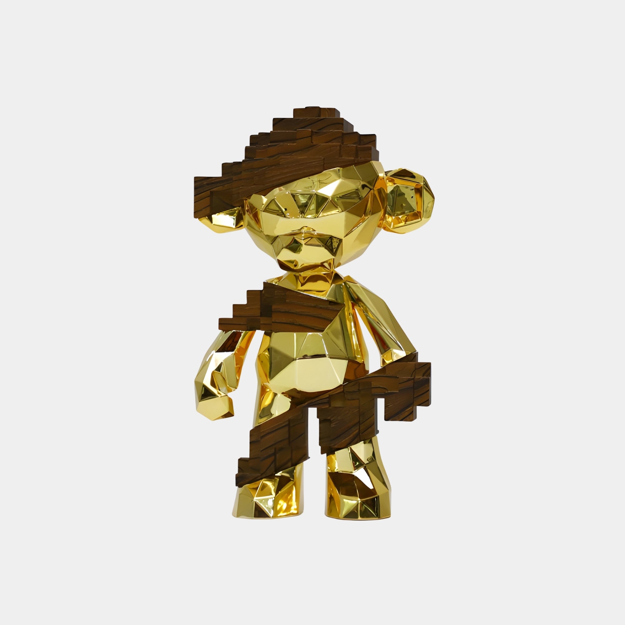 The Giant Sculptures Dark Wood & Gold Pixel Monkey Figure (35cm) features a golden, geometric monkey with faceted shapes, wearing a pixelated brown pirate hat and holding a pixelated object against a plain white background.