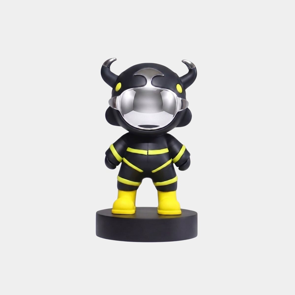 The Giant Sculptures Black Utility Astro Devil Figure - 15cm features a black body with yellow accents, a reflective silver horned helmet, yellow boots, and stands on a round black base against a plain white background.