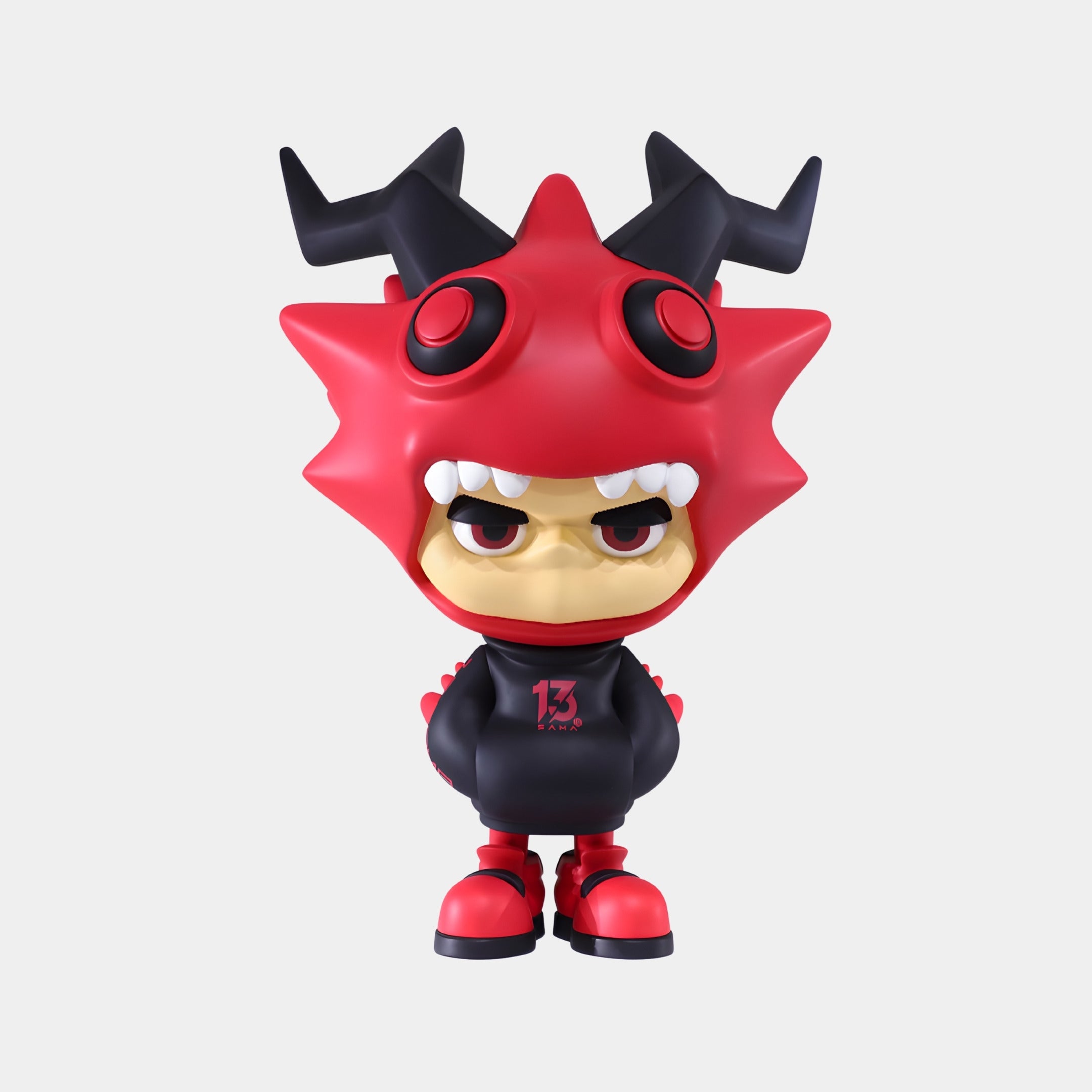 The 60cm Red & Black Horned Drakoz Sculpture by Giant Sculptures features an annoyed toy figure in a spiky monster suit, red shoes, and a black hoodie with “13”—a bold statement piece for any space.