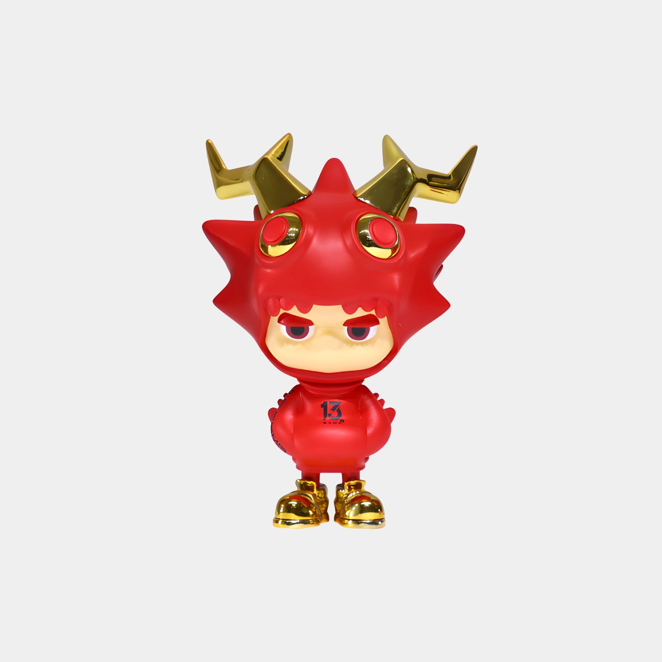 The Giant Sculptures Red & Gold Horned Drakoz Figure - 15cm features a spiky costume, electroplated gold horns and shoes, large round eyes, and a serious expression in a forward-facing pose against a white background.