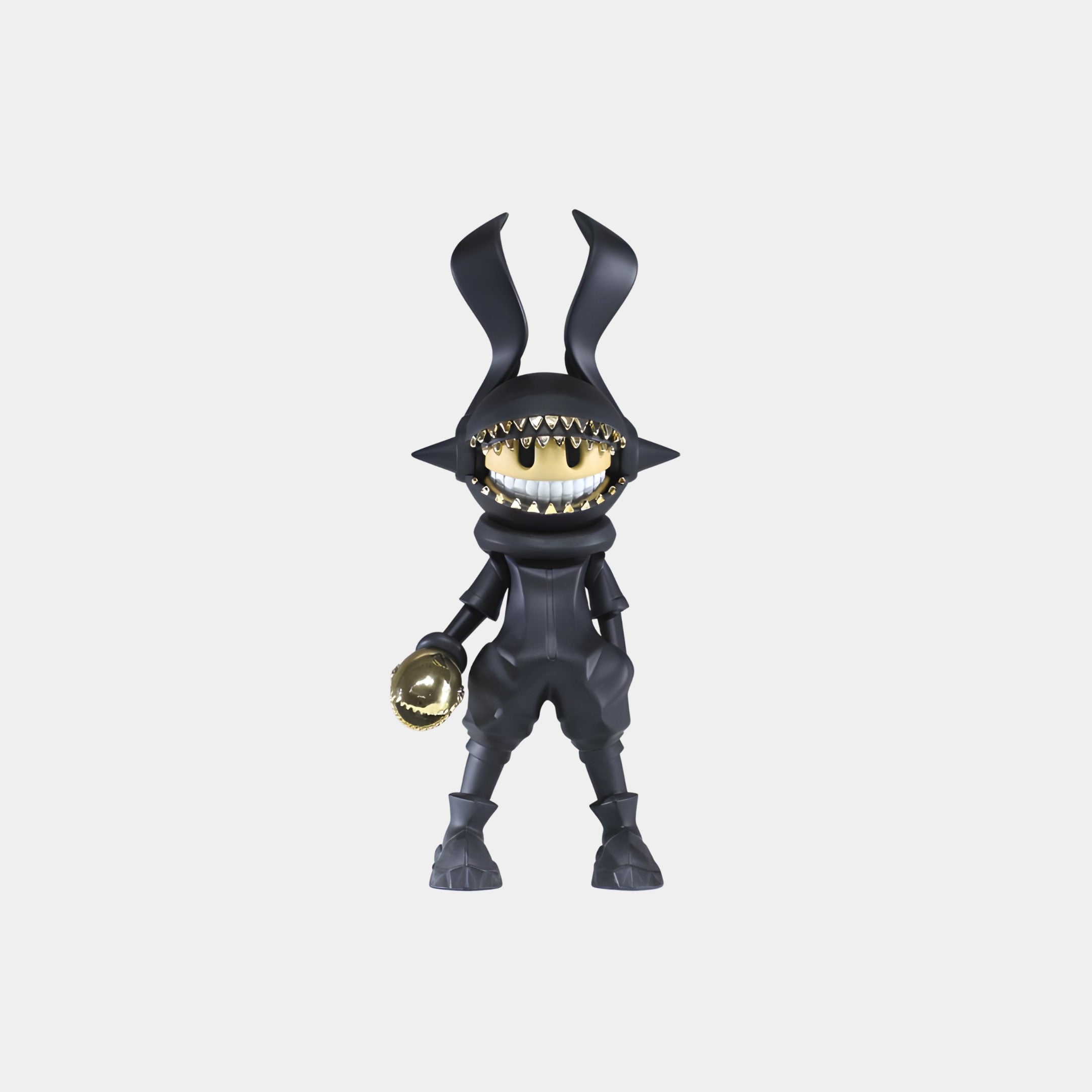 The Obsidian Gold Long Ear Grinzo Figure - 26cm by Giant Sculptures is a matte black collectible with long bunny ears, gold electroplated teeth, and holds a gold object in its right hand, set against a plain white background.