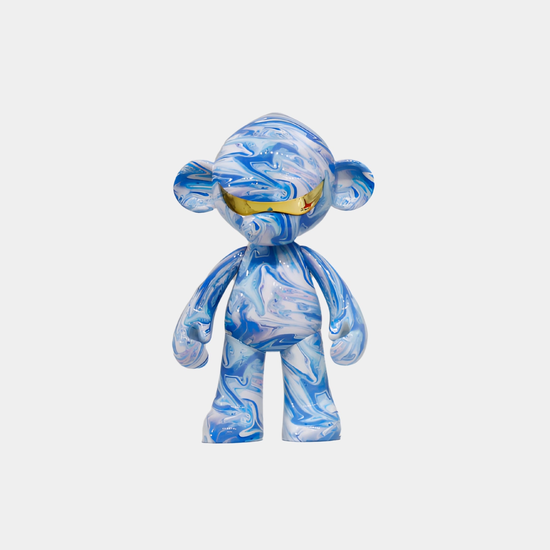 The Giant Sculptures Ocean Camo Monkey Figure (35cm) is a resin collectible with a swirling blue and white marble pattern, rounded ears, and yellow-tinted sunglasses, strikingly displayed against a plain white background.