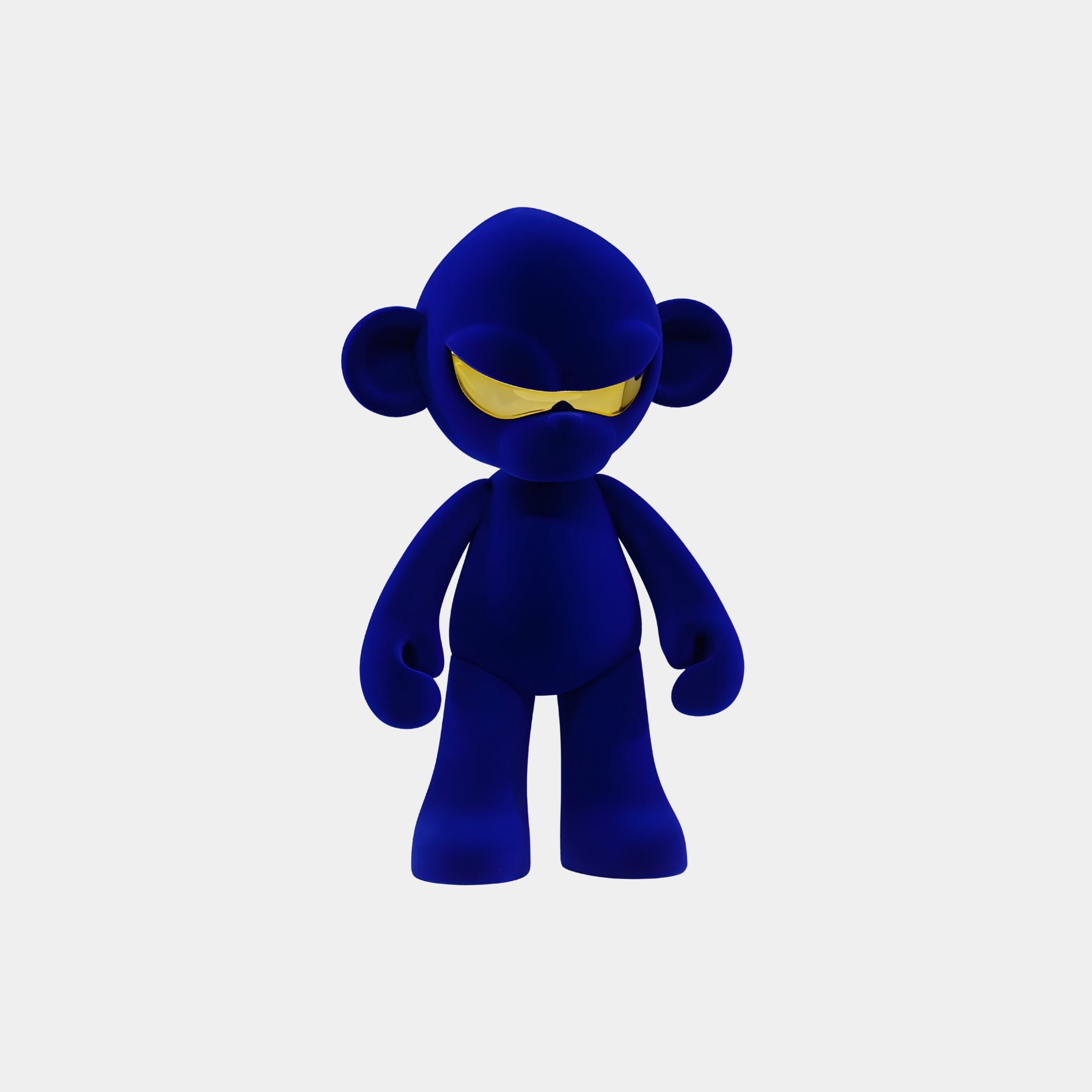 The Giant Sculptures Midnight Blue Colorblock Monkey Figure (35cm) stands upright in yellow futuristic sunglasses on a light gray background, featuring a smooth, minimalistic design crafted from premium resin.