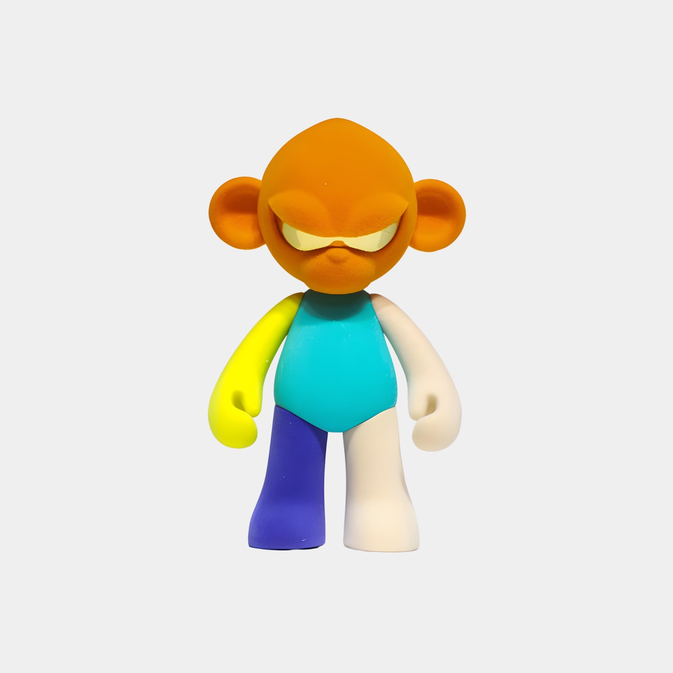 The Giant Sculptures Orange Head I Colorblock Monkey Figure (35cm) features an orange head and ears, yellow eyelids, blue-green body, and mismatched limbs, standing as a collectible sculpture against a plain white background.