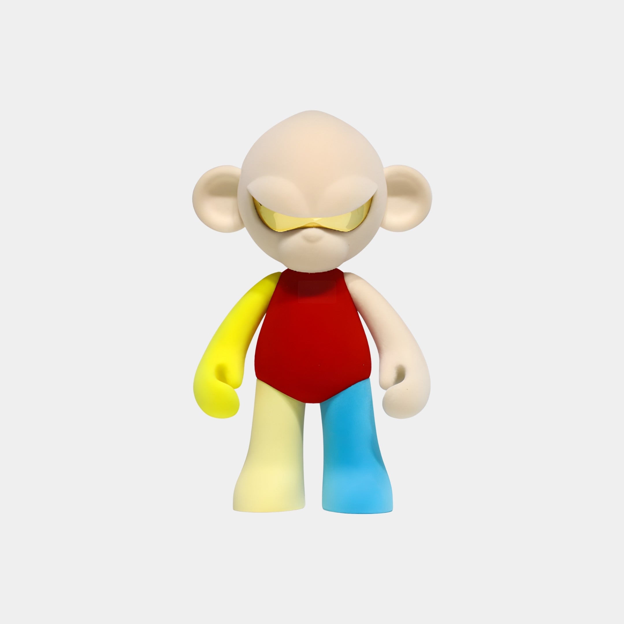 The Cream Head II Colorblock Monkey Figure (35cm) by Giant Sculptures features a large-headed cartoon monkey with a yellow visor and primary color blocks—red torso, yellow left arm and leg, white right arm, blue right leg—on a light gray background.