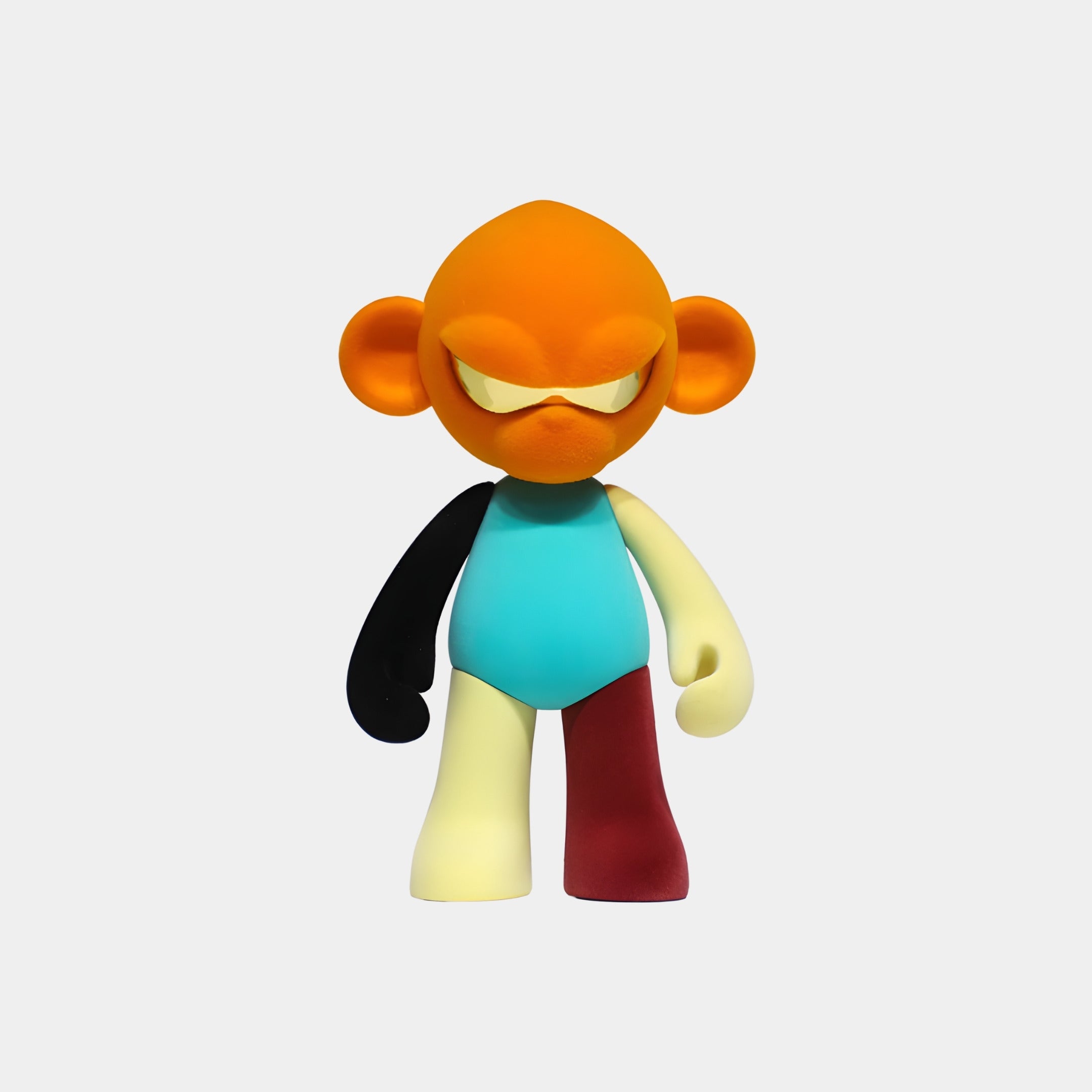 The Orange Head II Colorblock Monkey Figure (35cm) by Giant Sculptures features an orange head, large ears, and mismatched limbs—a vibrant collectible sculpture perfect for playful display against a plain white background.