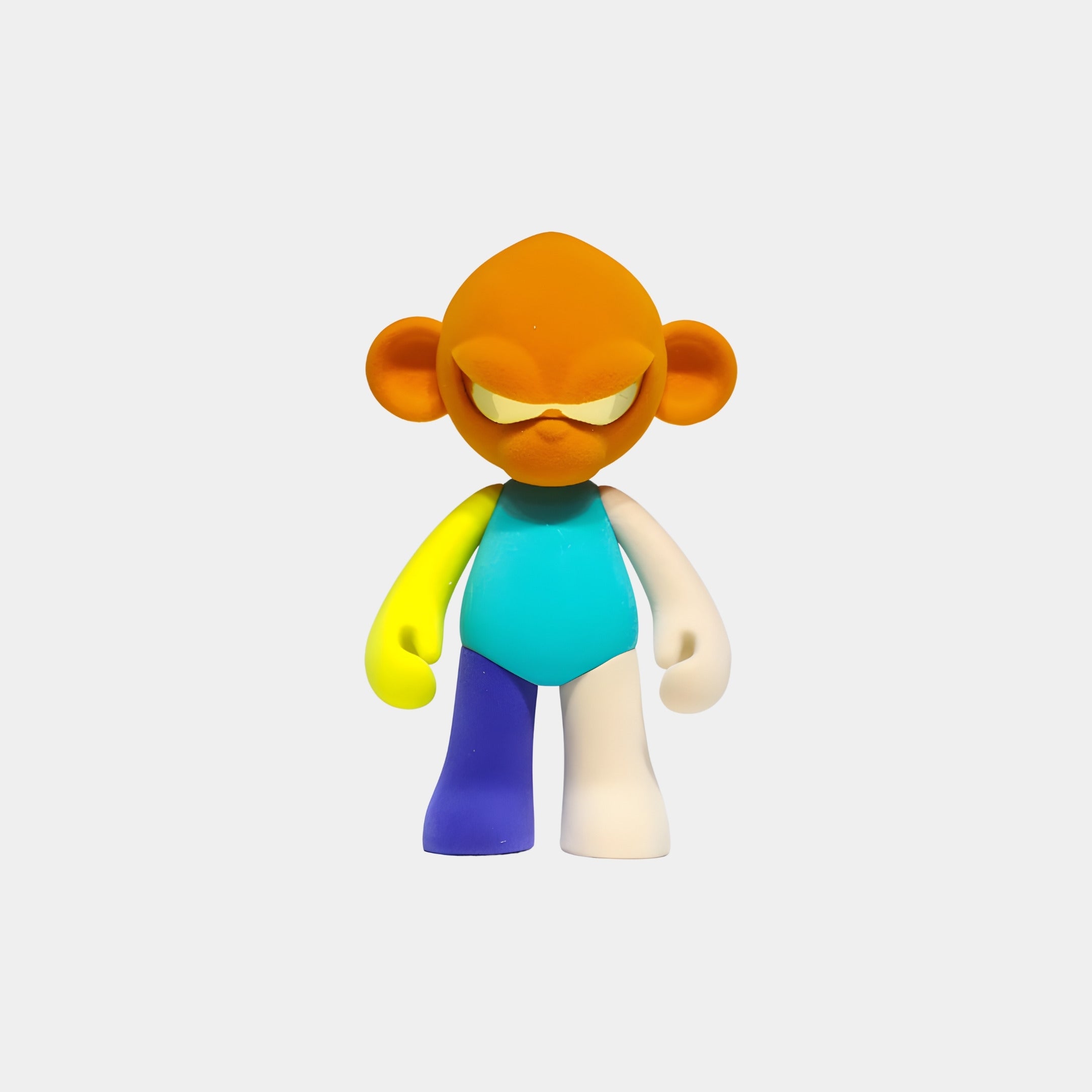 The Orange Head I Colorblock Monkey Figure (15cm) by Giant Sculptures features vibrant orange, turquoise, yellow, blue, and white details in a playful resin design—perfect as a collectible or decor piece.