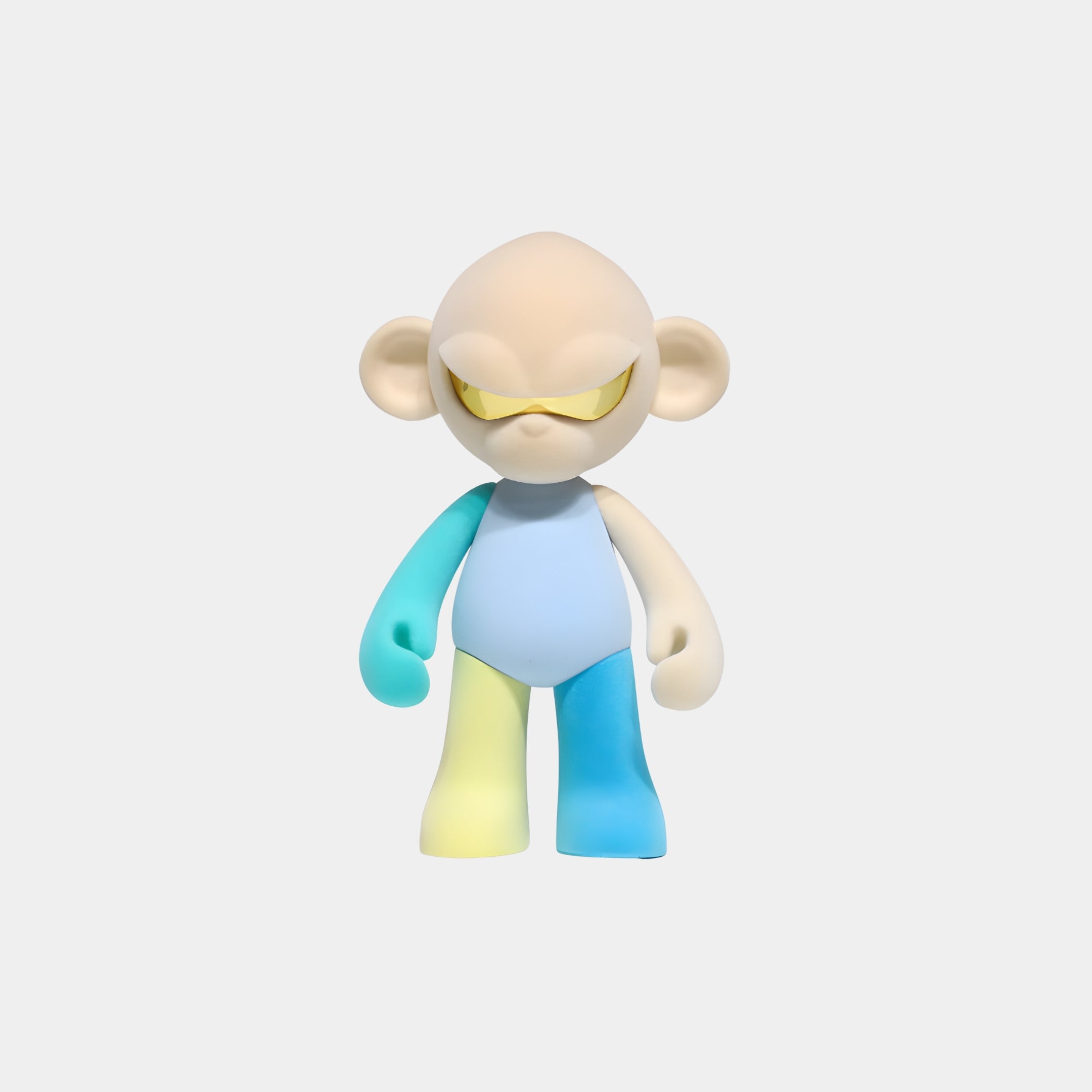 The Cream Head III Colorblock Monkey Figure (15cm) by Giant Sculptures features a large head, yellow-tinted glasses, blue and white arms, and multicolored legs—perfect as a playful resin collectible for pastel decor.