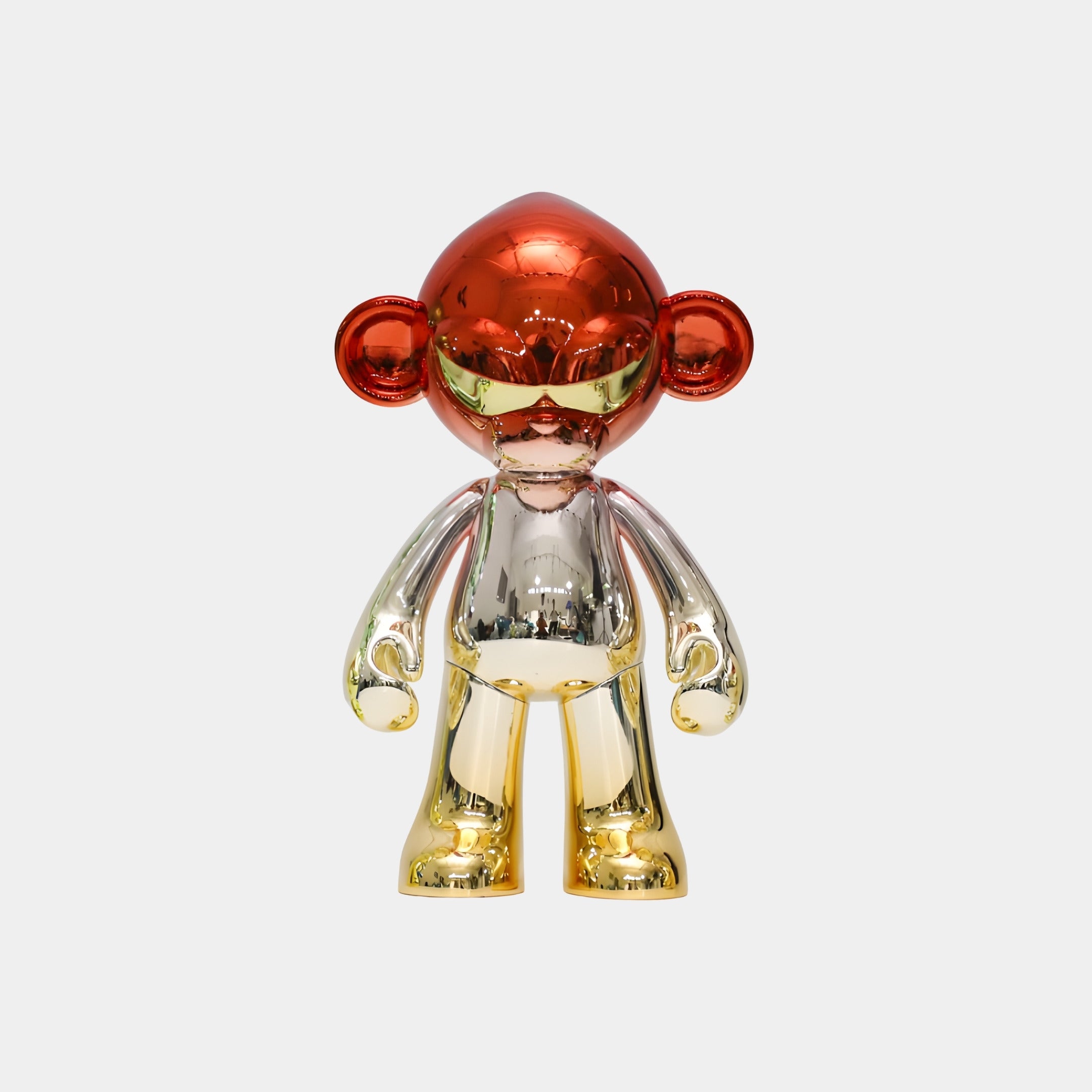 The Crimson Gold Chrome Monkey Figure - 35cm by Giant Sculptures features a chrome-plated resin design with a red head and ears, gold hands and feet, and a silver torso, standing upright against a plain white background.