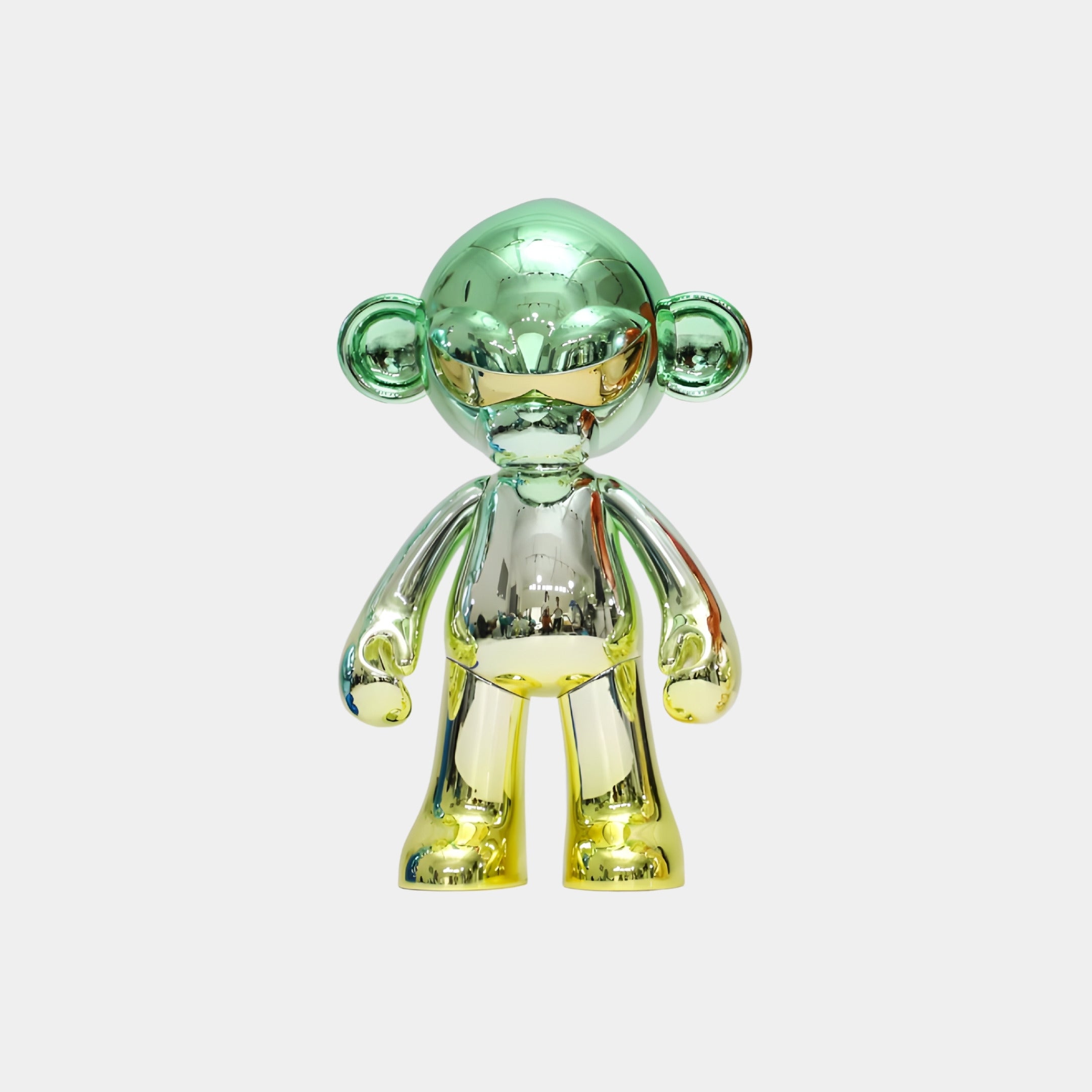 The Giant Sculptures Lime Fade Chrome Monkey Figure (35cm) features a shiny, mirror-finish metallic design with green, silver, and yellow hues, standing upright against a plain white background.