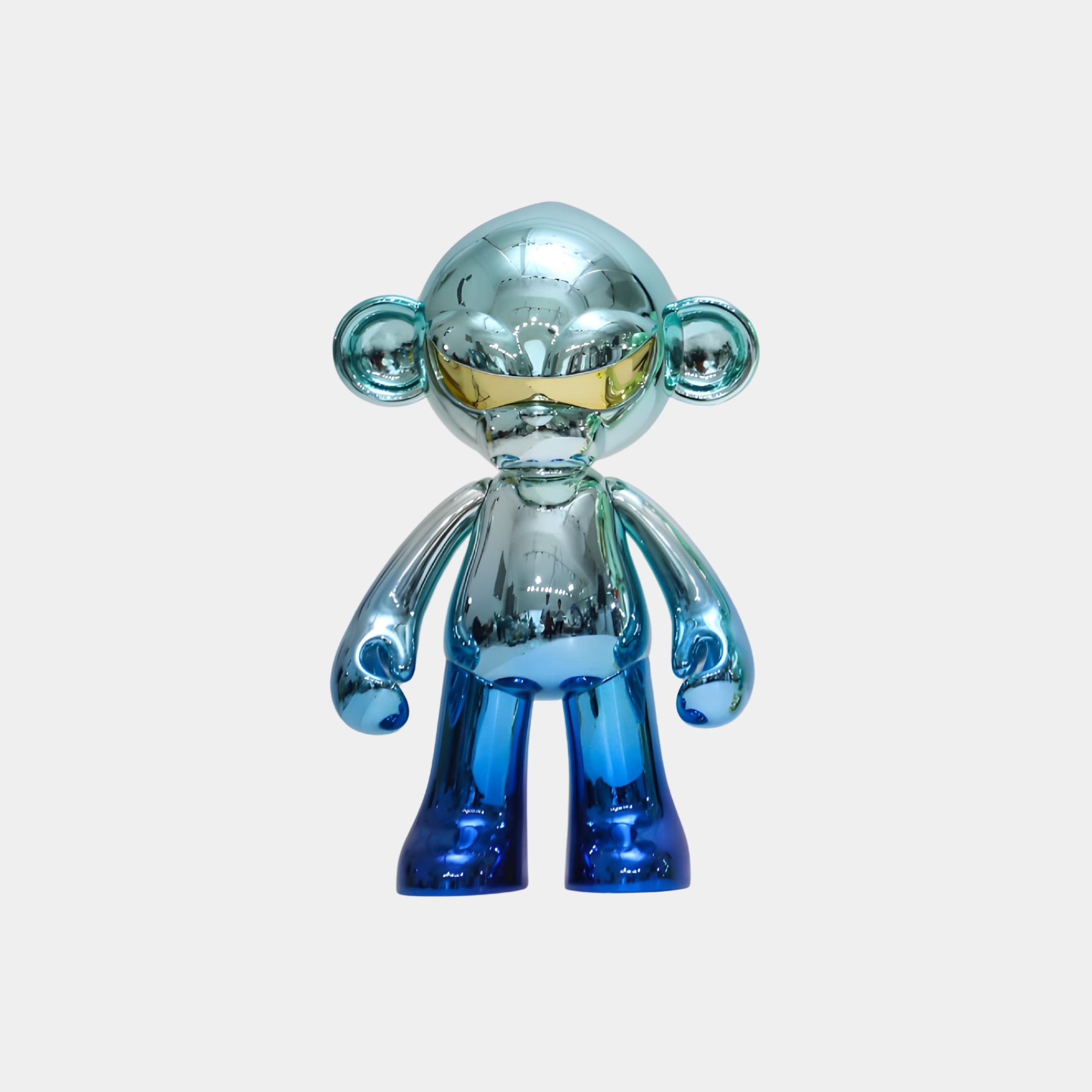 The Aqua Blue Fade Chrome Monkey Figure - 35cm by Giant Sculptures is a shiny, metallic blue and silver collectible with large round ears and a reflective finish, shown standing upright against a plain white background.