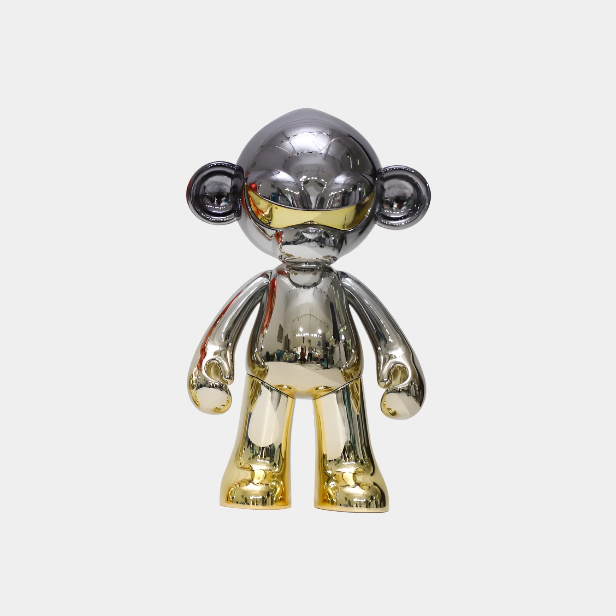 The Giant Sculptures Obsidian Gold Chrome Monkey Figure (35cm) is a collectible with a shiny gold and silver metallic finish, styled like a cartoon monkey, displayed facing forward against a plain white background.