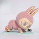 The Giant Sculptures Lazy Yoga Ab Roller Labubu Sculpture (100cm) features a pink bunny with a big head, spiral eyes, and a wide grin doing a push-up over a small digital clock on a light blue mat, mimicking an ab roller workout.