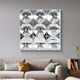A modern living room with a light gray sofa, yellow and black accent pillows, and the Giant Sculptures Haloid I Bubble Grid Acrylic 3D Wall Art featuring nine clear spheres arranged in a square grid above the couch.