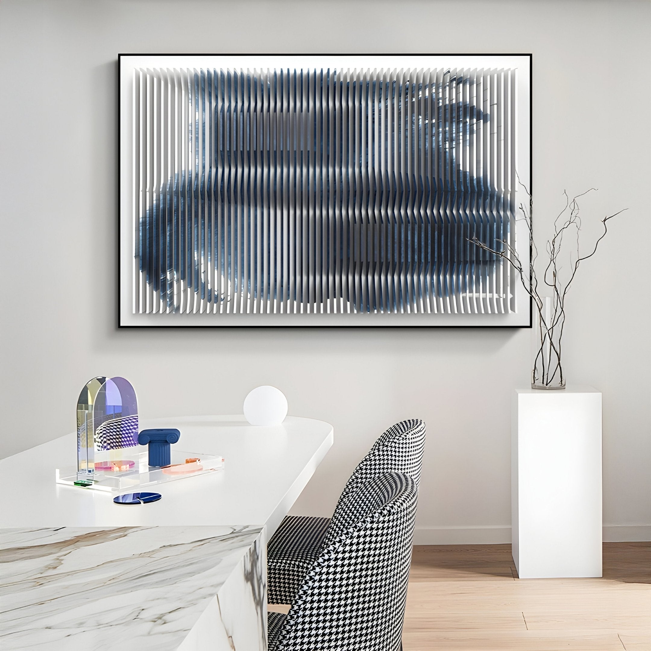 A modern dining area features a marble table, patterned chairs, and vibrant glass decor. The wall displays Nebula I Midnight Swirl Acrylic 3D Wall Art by Giant Sculptures, while a tall pedestal holds a striking branch arrangement.