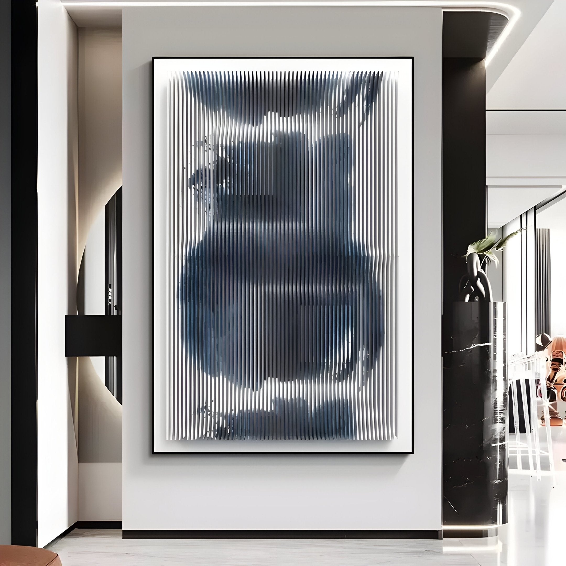 The Nebula II Midnight Swirl Acrylic 3D Wall Art by Giant Sculptures, featuring vertical blue, gray, and white ridges, hangs on a white wall in a sleek, minimalist contemporary space.