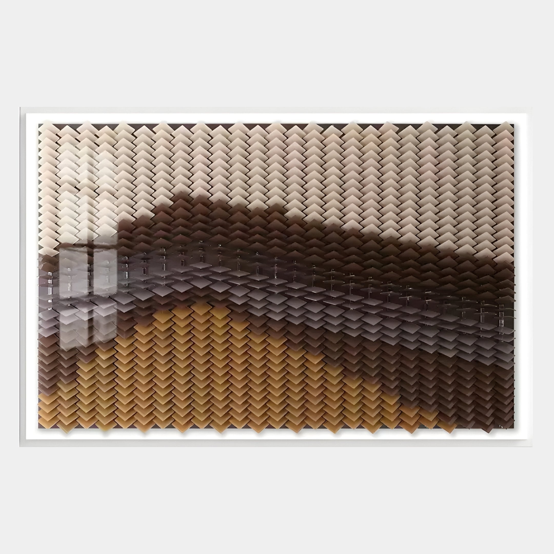 The Tessera Caramel & Walnut Gradient Acrylic 3D Wall Art by Giant Sculptures features a chevron pattern in cream, brown, and yellow with a glossy finish that reflects light.