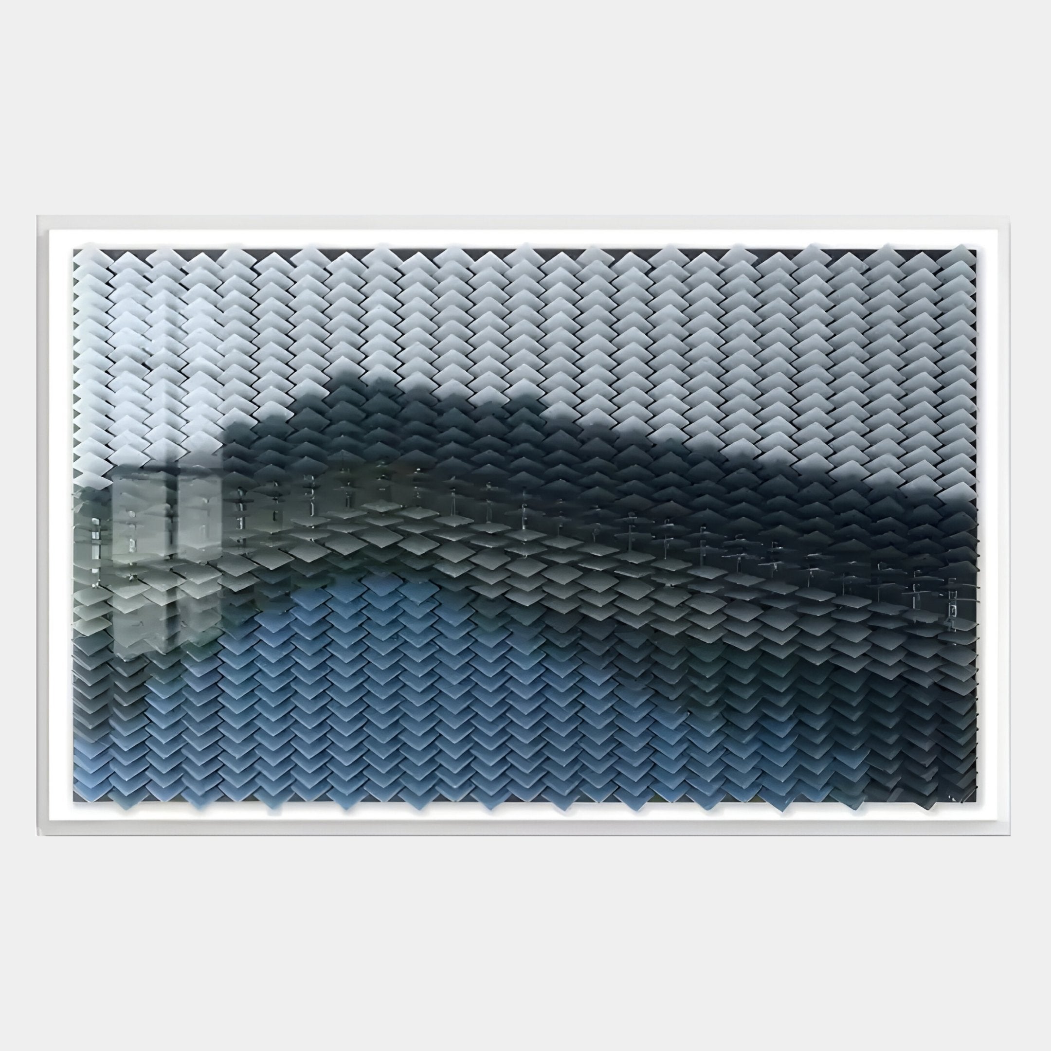 The Tessera Frosted & Midnight Blue Gradient Acrylic 3D Wall Art by Giant Sculptures showcases small, overlapping chevrons in gray, blue, and black, forming a striking wave-like gradient—perfect for fans of Gradient Wall Art.