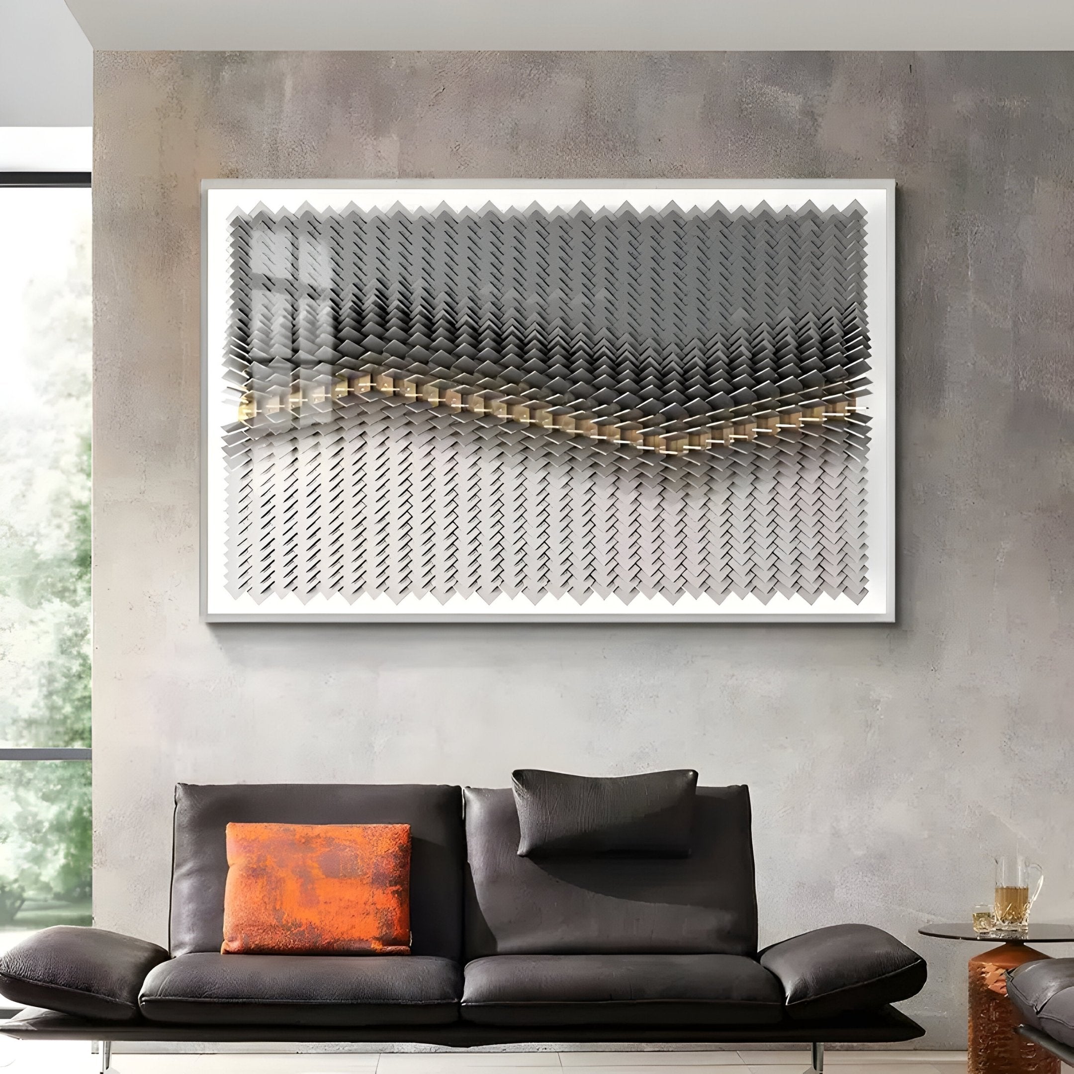 A modern living room features a dark gray sofa with an orange pillow, a small round side table, and Tessera Ash Grey & Warm Sandline Acrylic 3D Wall Art by Giant Sculptures with layered gold wavy patterns above the couch.