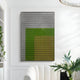 A modern painting with black and white geometric patterns hovers above a gradient of gray, lime green, and gold, capturing the chic style of Giant Sculptures’ Pixelate Lime Gold Acrylic 3D Wall Art in a bright, elegant room.