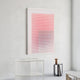 A modern, minimal room featuring the Pixelate Scarlet Blush Acrylic 3D Wall Art by Giant Sculptures—a bold grid of red circles fading to white—paired with a white mesh chair, small gray table, and brown vase for a balanced touch.