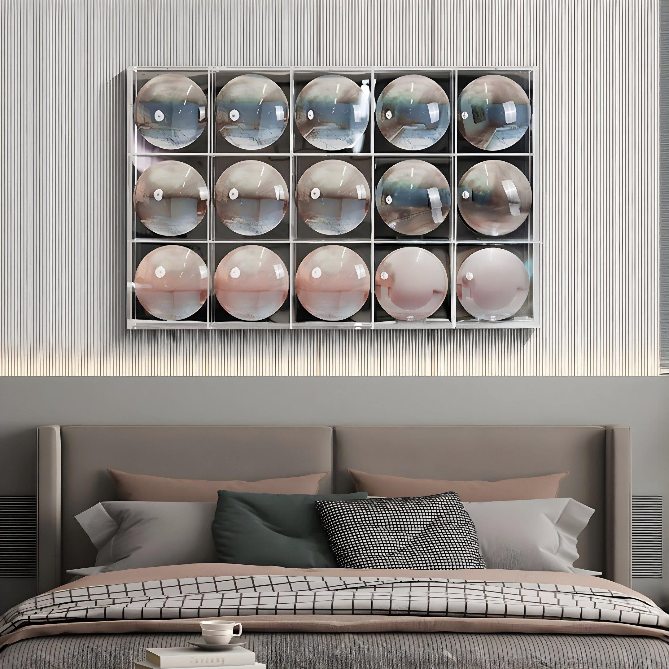 A modern bedroom features a neatly made bed beneath the Reflect Misty Rose & Storm Blue Mirror Acrylic 3D Wall Art by Giant Sculptures, with 15 convex mirrors on a wall-mounted shelf, adding striking sculptural style and geometric flair.