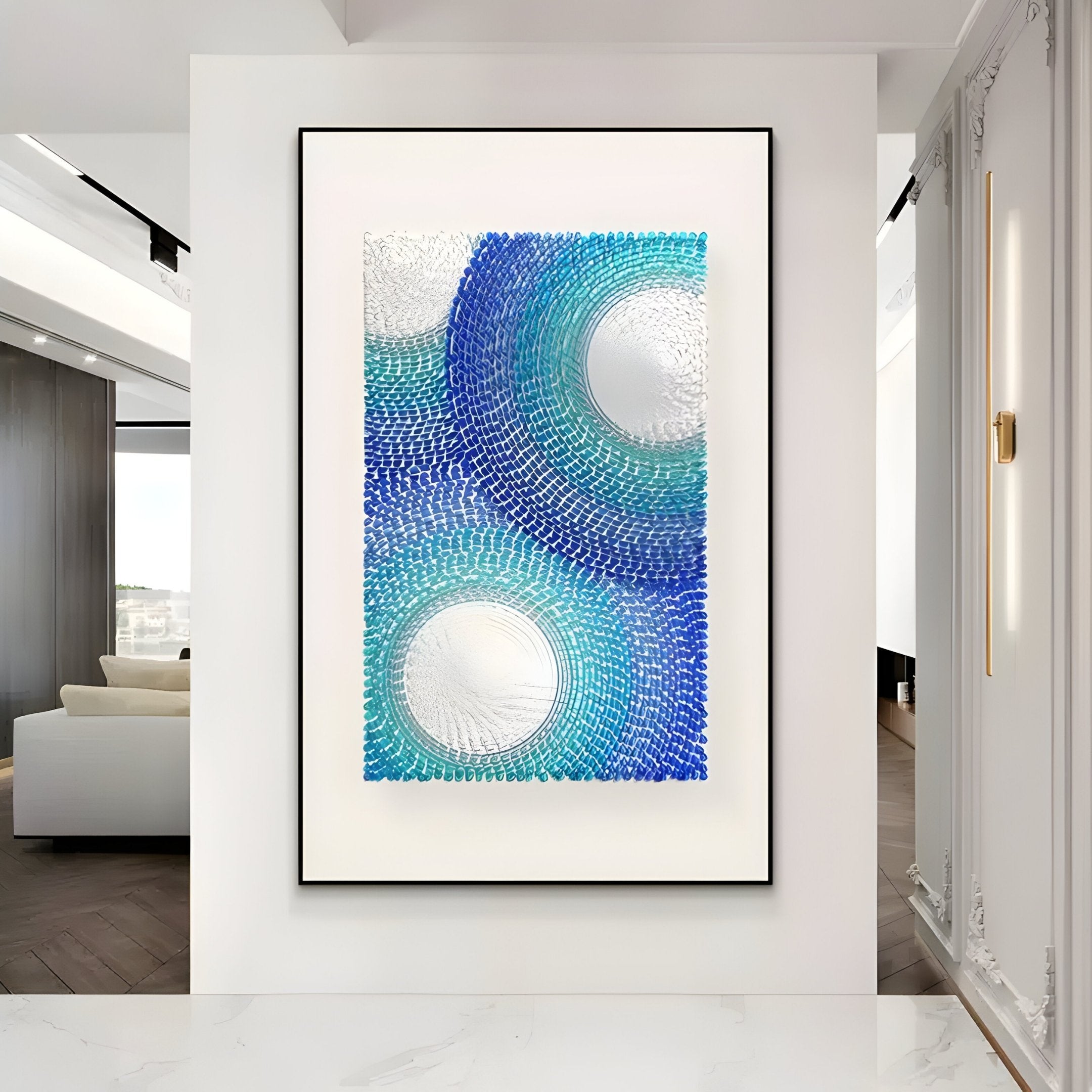 The Glaciera Ripple Blue Aqua Silver Acrylic 3D Wall Art by Giant Sculptures, featuring abstract concentric circles in blue, teal, and silver, adds modern flair to a minimalist white hallway with marble floors.