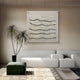 A modern living room with a white sectional, green ottoman, tall potted plant, and Tanglewave Ivory & Charcoal Ripple Texture Acrylic 3D Wall Art by Giant Sculptures. Neutral tones and sunlight create a calm, minimalist feel.