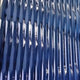 Close-up of Giant Sculptures Current III Navy Sky & Icy White Acrylic 3D Wall Art, featuring a textured blue surface with glossy, wavy ridges that create dynamic reflections—ideal as modern sculptural wall art for any space.
