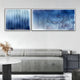 A modern living room with a light gray sofa, a round white table with dried flowers, and Giant Sculptures Current I Navy Sky & Icy White Acrylic 3D Wall Art as bold, abstract wave-patterned decor above the sofa.