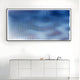 A modern kitchen features a white minimalist cabinet with a kettle and decor. Above, the Giant Sculptures Current II Navy Sky & Icy White Acrylic 3D Wall Art adds an artistic touch with wavy blue lines on a light background.