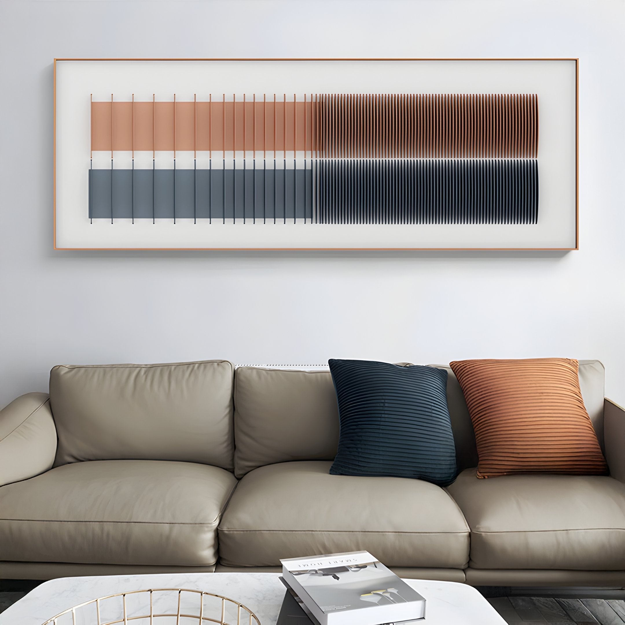 A modern living room with a light gray sofa, two striped navy and rust pillows, a marble-top coffee table with books, and Giant Sculptures Flowline I Dual Tone Copper & Charcoal Acrylic 3D Wall Art as a striking focal point.