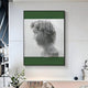 A modern living space showcases the Edge Forest Green David Bust Leather & Acrylic 3D Wall Art by Giant Sculptures, with a profile design in green and white. Minimalist decor and plants complete the fresh, modern Renaissance style.