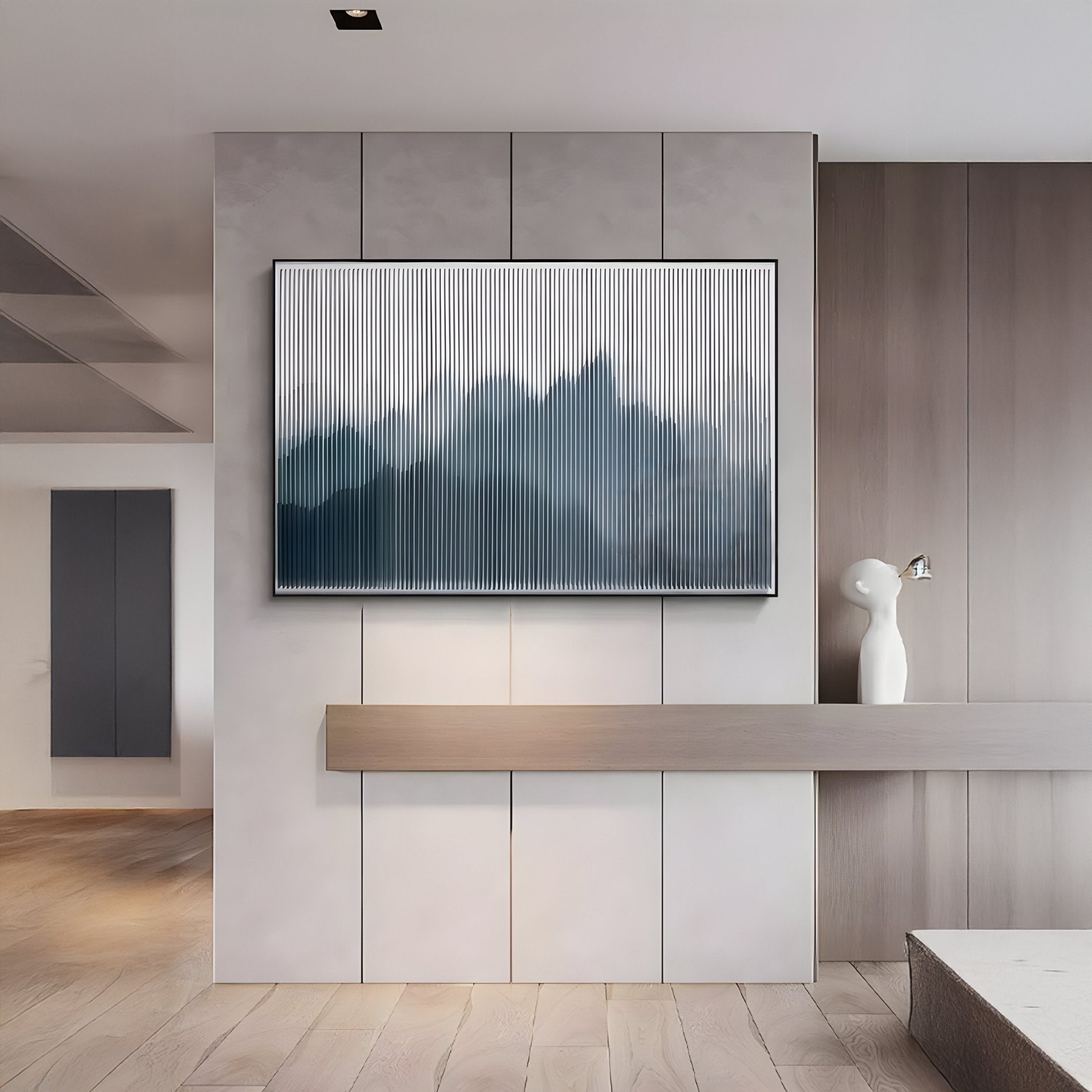 A minimalist living space showcases Giant Sculptures Horizon I Slate Mist Mountain Acrylic 3D Wall Art above a sleek floating shelf, paired with a small white decorative sculpture. Neutral tones and clean lines complete the modern look.