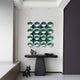 A modern entryway features a black sculptural console, decorative objects, a black dog statue, and striking Dome Emerald Green Acrylic 3D Wall Art by Giant Sculptures—16 reflective spheres arranged in a grid for a contemporary touch.