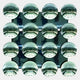 Sixteen reflective emerald green acrylic domes in a 4x4 grid by Giant Sculptures, each mirroring a bright, windowed ceiling—Dome Emerald Green Acrylic 3D Wall Art is striking modern décor for any space.