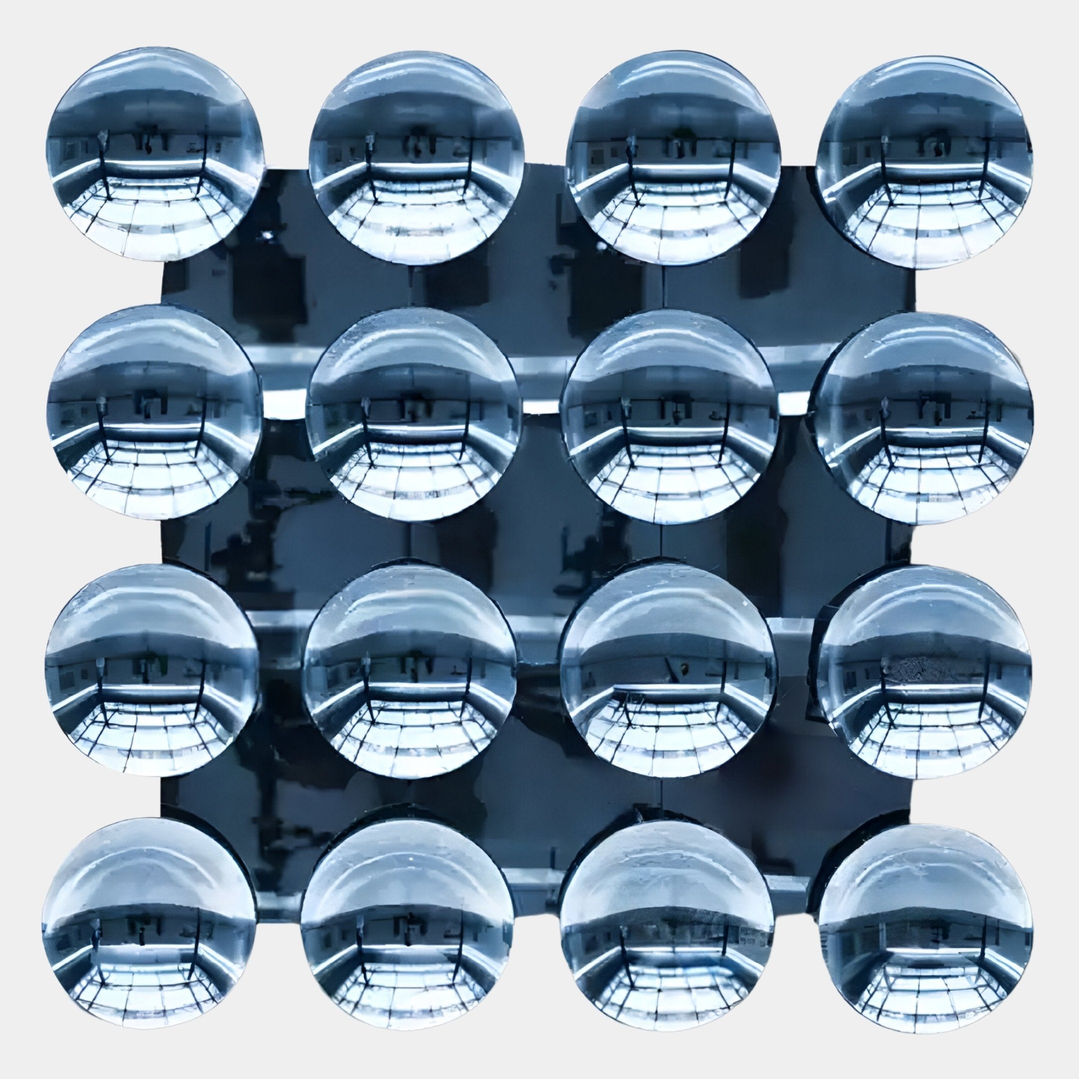 Sixteen glass-like spheres in a 4x4 grid reflect an industrial-style ceiling, creating striking contemporary 3D artwork. The Dome Ice Blue Acrylic 3D Wall Art by Giant Sculptures adds a modern touch to any white-walled space.