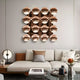 A modern living room with a white sectional sofa, decorative pillows, a small round table lamp, and Giant Sculptures Dome Burnished Copper Acrylic 3D Wall Art—a sculptural 4x4 grid of shiny round pieces—displayed above the couch.