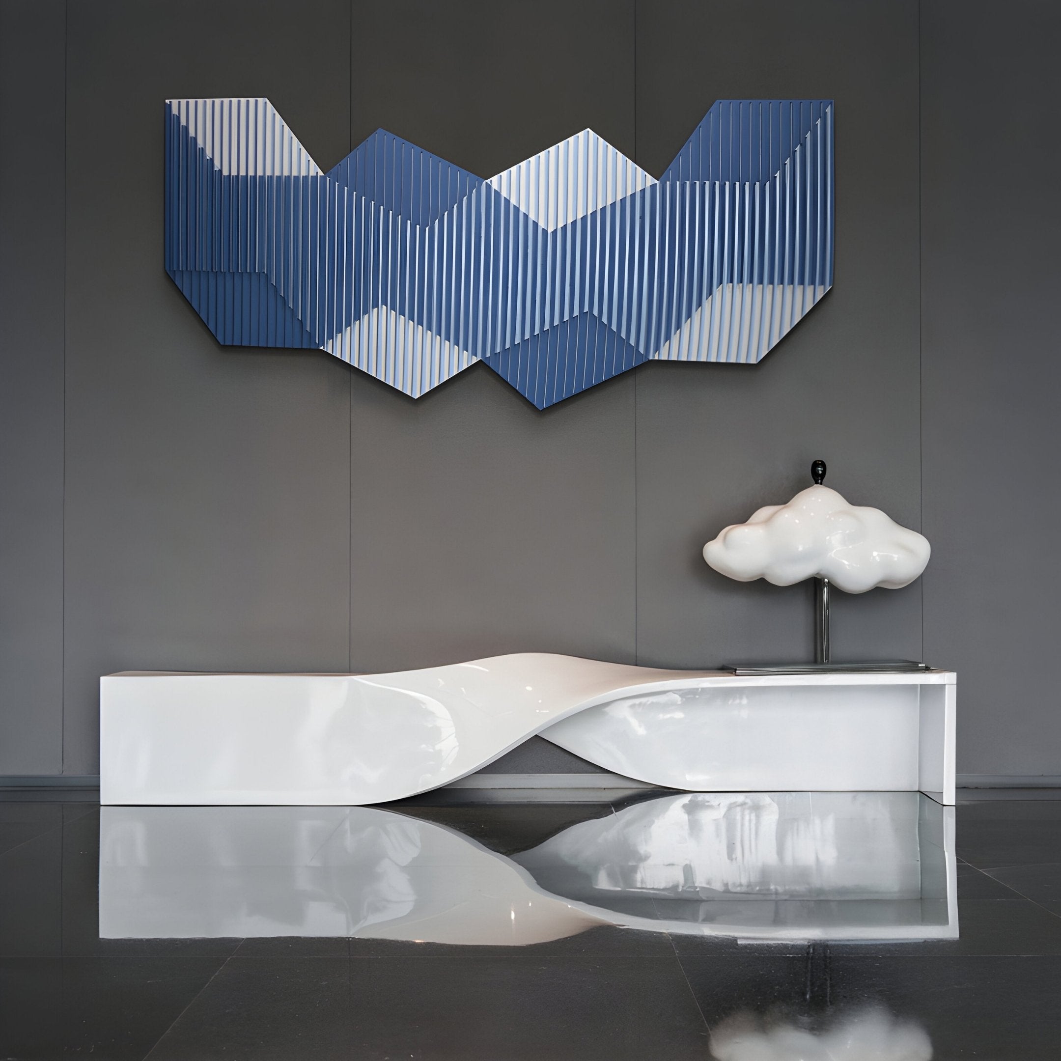 A modern interior showcases Giant Sculptures’ Vertex Deep Navy & White Ridge Acrylic & Wood Carving 3D Wall Art, paired with a white sculptural bench and a cloud-shaped lamp, all set against a dark gray wall and glossy floor.