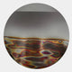 Iridia Halo III Abstract Acrylic UV Wall Art by Giant Sculptures, circular disc with mirrored upper half and multicoloured wavy heat-mark lower band on a white wall.