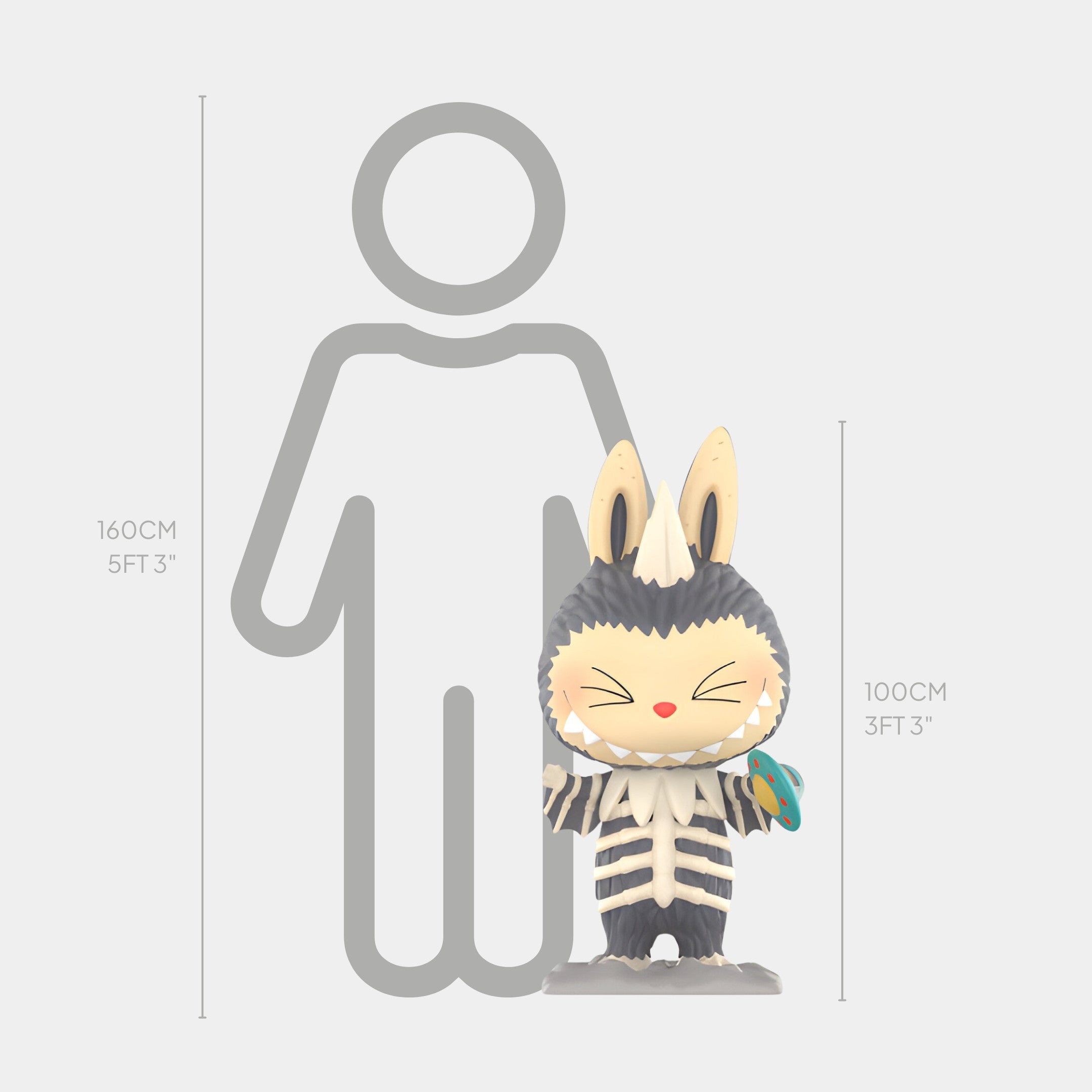 The Giant Sculptures Monsterverse Alien Kaiju Labubu Sculpture - 100cm, a cartoonish figurine with large ears and striped fur, stands 100 cm (3 ft 3 in) tall next to a gray human outline marked at 160 cm (5 ft 3 in).