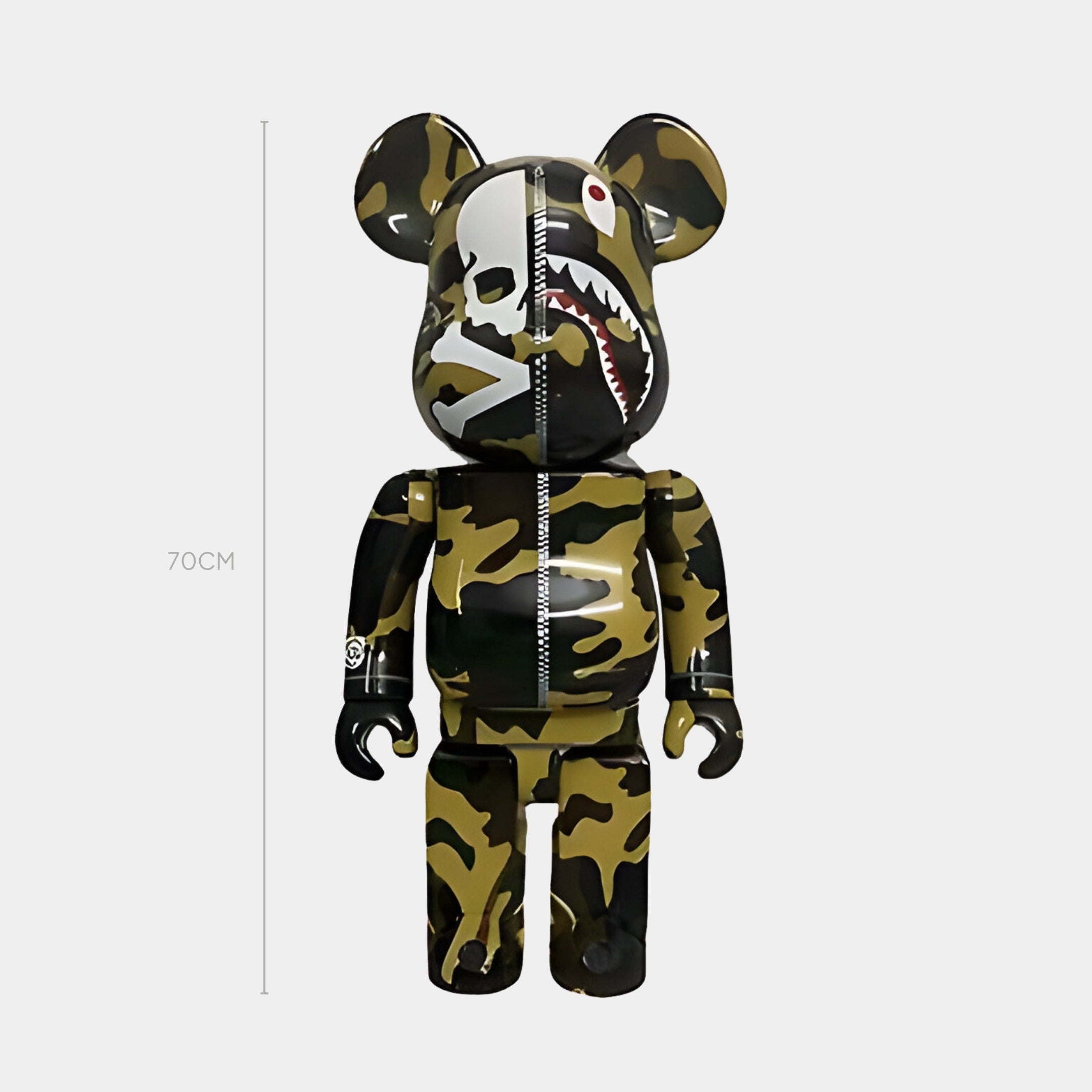 The Giant Sculptures Apex Split Bear Sculpture - 70cm stands upright against a white background, showcasing a designer bear with urban camo, a center zipper detail, and a shark face graphic on its head.