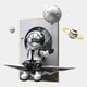 The Silver Balloon Astronaut 3D Portal Wall Art by Giant Sculptures features a silver astronaut on a floating platform with a moon balloon, surrounded by ringed planets—blending whimsy and futuristic cosmic exploration.