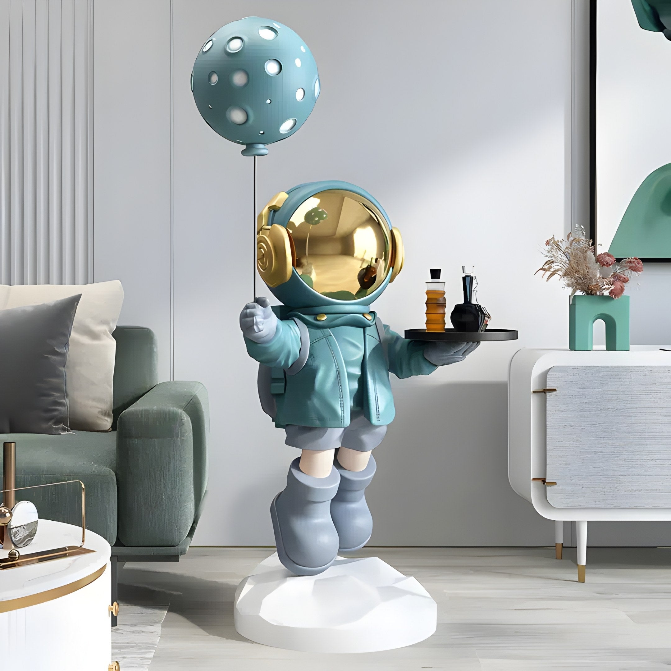 The Galactic Blue Astronaut Butler Balloon Sculpture by Giant Sculptures, featuring a teal-suited figure holding a balloon and tray on a white base, perfectly complements the space-themed décor of your modern living room with its green sofa, abstract art, and minimalistic style.