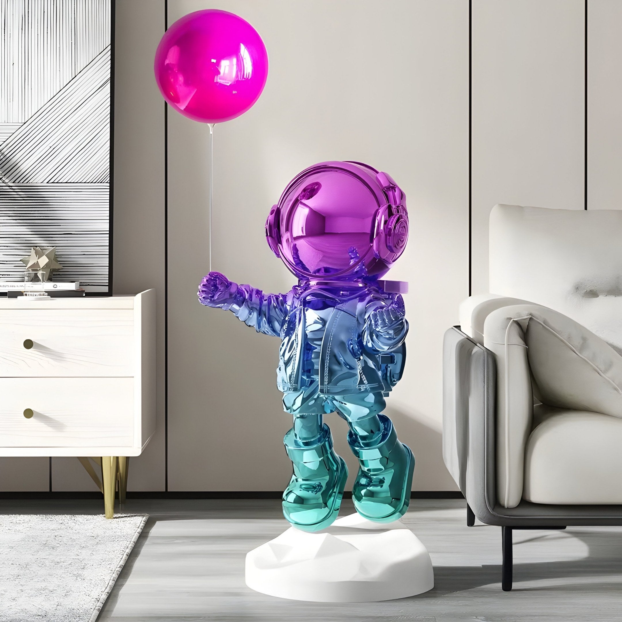 A 110cm Vibrant Gradient Astronaut Balloon Sculpture by Giant Sculptures, featuring shiny purple and teal hues, stands in a modern living room alongside a white sideboard, monochrome artwork, and a beige couch.