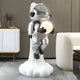 Lunar Silver Astronaut Glow Lift-Off Sculpture by Giant Sculptures, 110cm resin figure in silver suit rising from a white cloud base, holding a glowing orb, in a modern living room.
