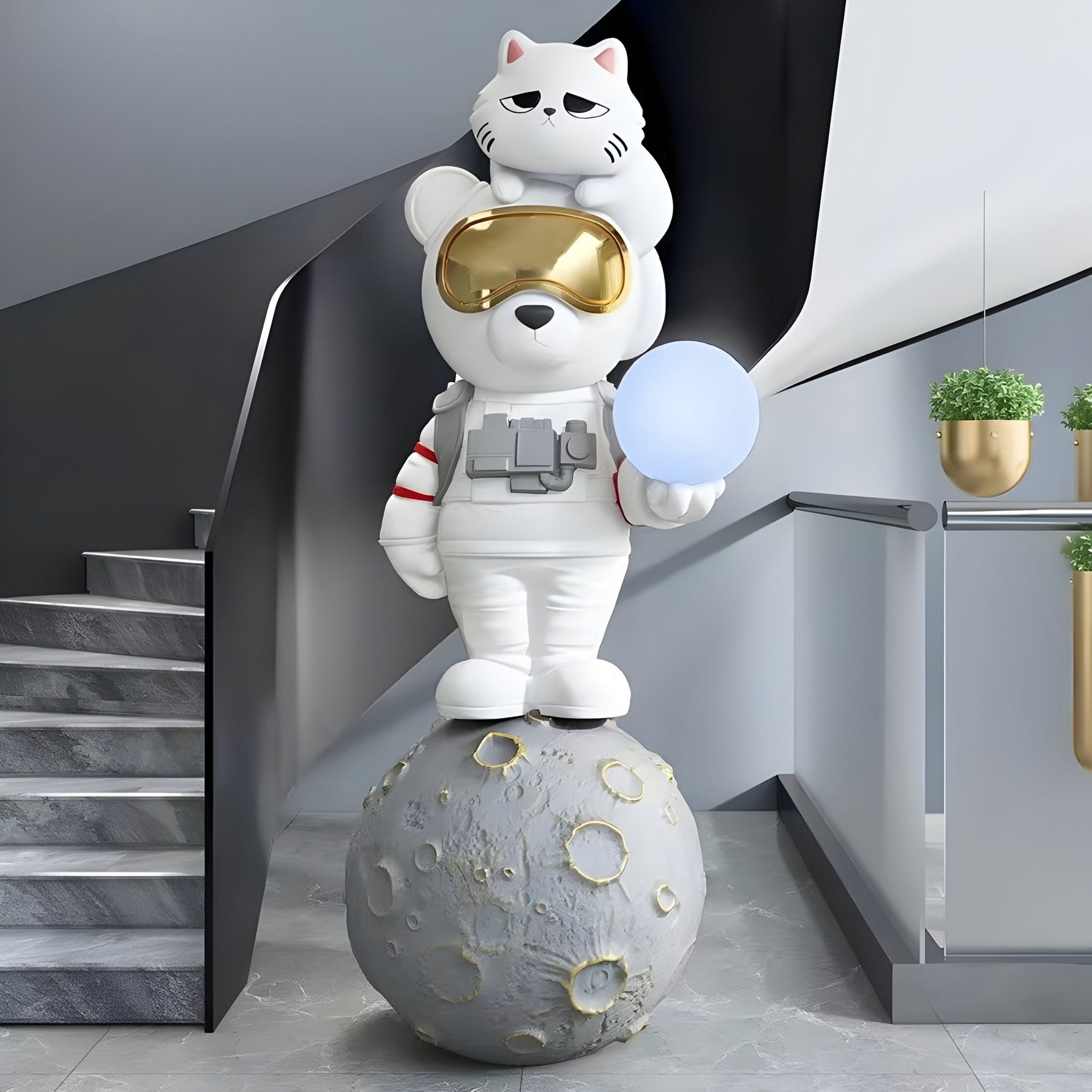 Introducing the White Astronaut CosmoPals Glow Bear Sculpture (115cm) by Giant Sculptures: a bear in an astronaut suit with a gold visor stands on a moon surface ball, holding a glowing orb, while a cat sits atop its head—an elegant interstellar décor for your staircase landing.