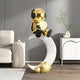 The Giant Sculptures Celestial Gold Astronaut Glow Moon Crescent Sculpture (116cm) features a luminous astronaut on a white crescent moon with gold cloud accents—ideal for modern, minimalist living rooms seeking elegant, celestial decor.