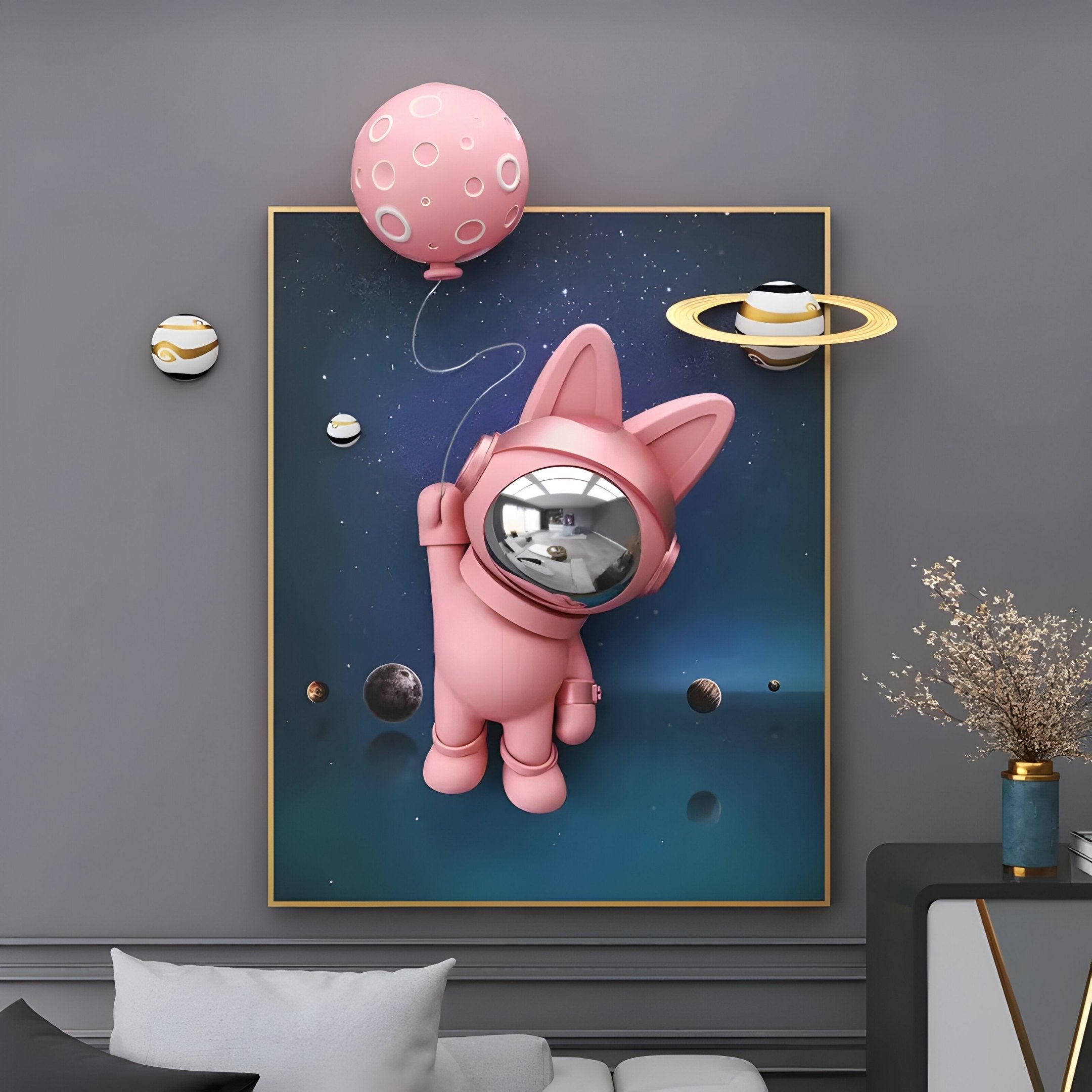 The Pink 3D Astronaut Bunny Balloon Starry Wall Art by Giant Sculptures features a pink astronaut bunny floating in space with a balloon and planets, alongside two round wall hangings and a vase with dried flowers on the gray wall, creating an otherworldly scene.