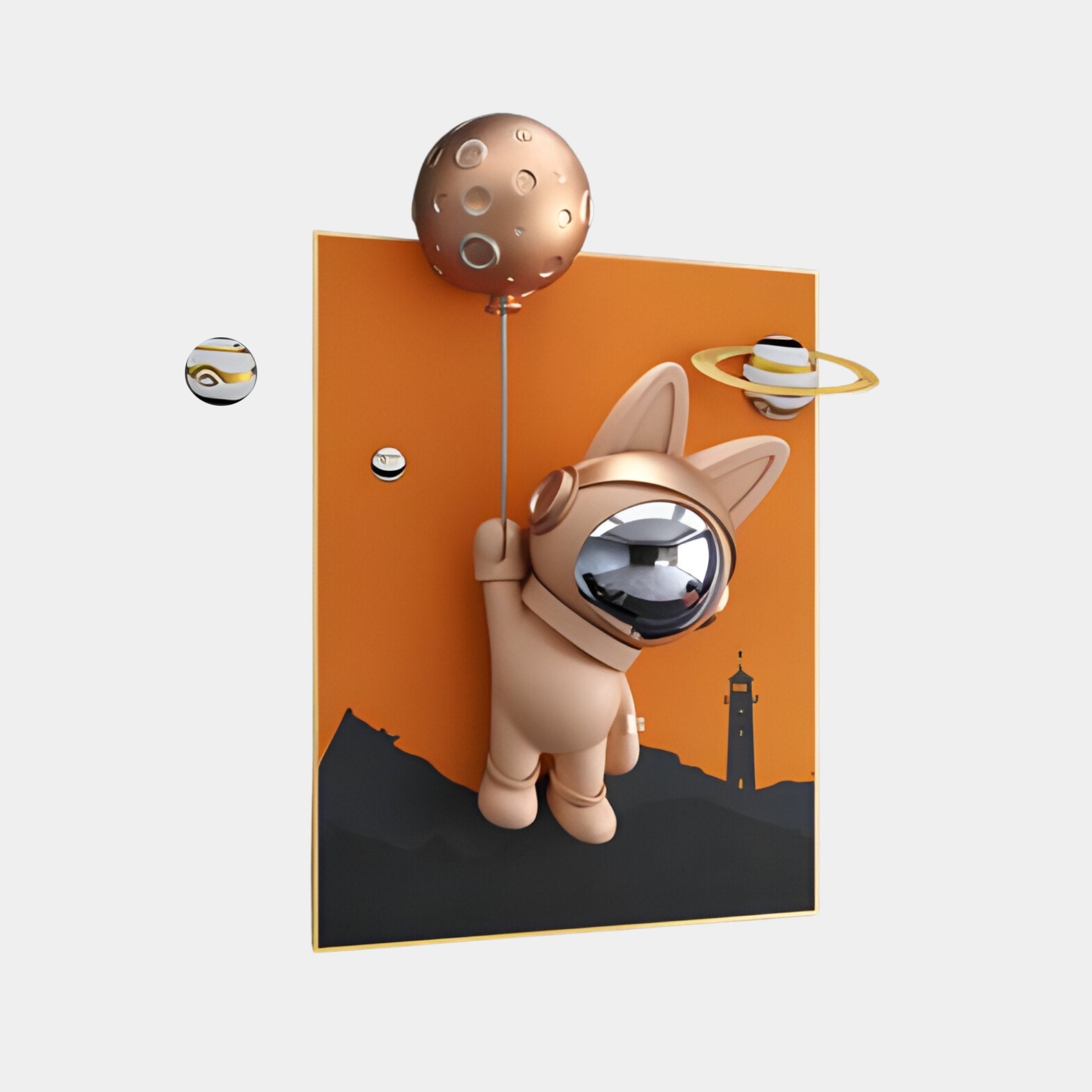 The Rose Gold 3D Astronaut Bunny Balloon Lighthouse Wall Art by Giant Sculptures features a cute astronaut cat with a rose gold helmet, floating in space with a bunny balloon against an orange background of mountain silhouettes, a lighthouse, and small planets for dreamy, space-themed accents.